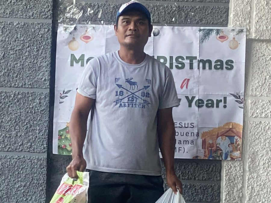 CMMF Noche Buena distribution — a family receiving Christmas aid