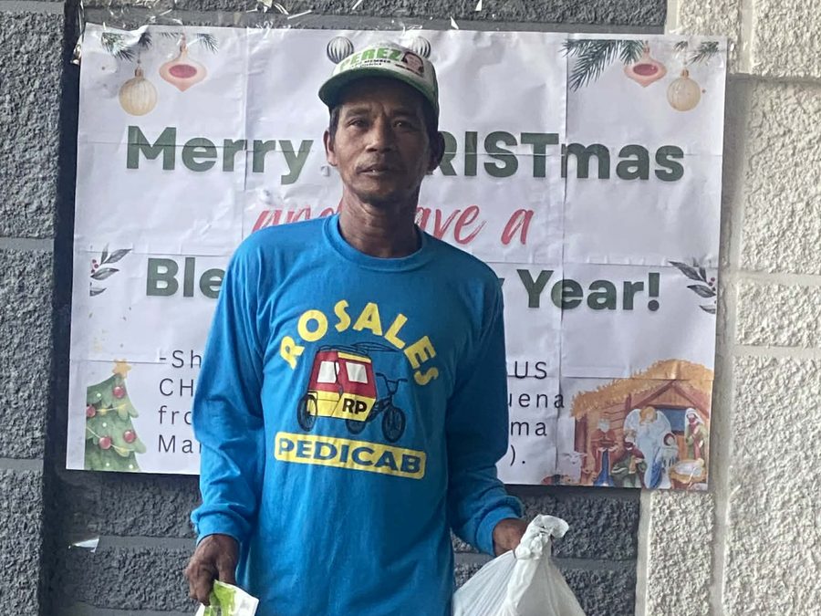 CMMF Noche Buena distribution — a family receiving Christmas aid
