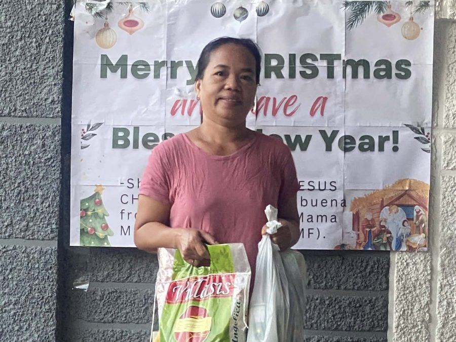 CMMF Noche Buena distribution — a family receiving Christmas aid