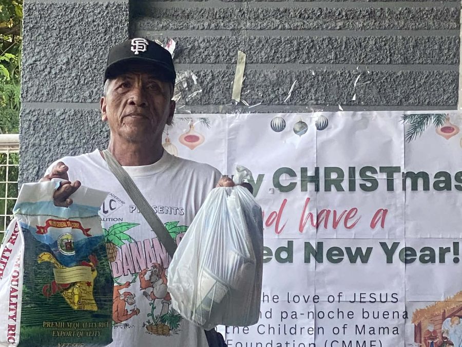 CMMF Noche Buena distribution — a family receiving Christmas aid