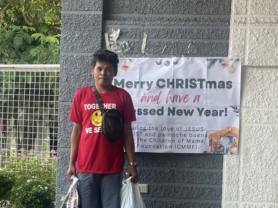 CMMF Noche Buena distribution — a family receiving Christmas aid