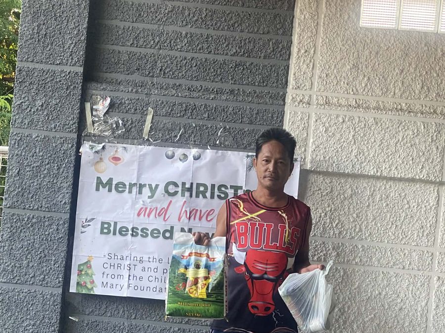 CMMF Noche Buena distribution — a family receiving Christmas aid