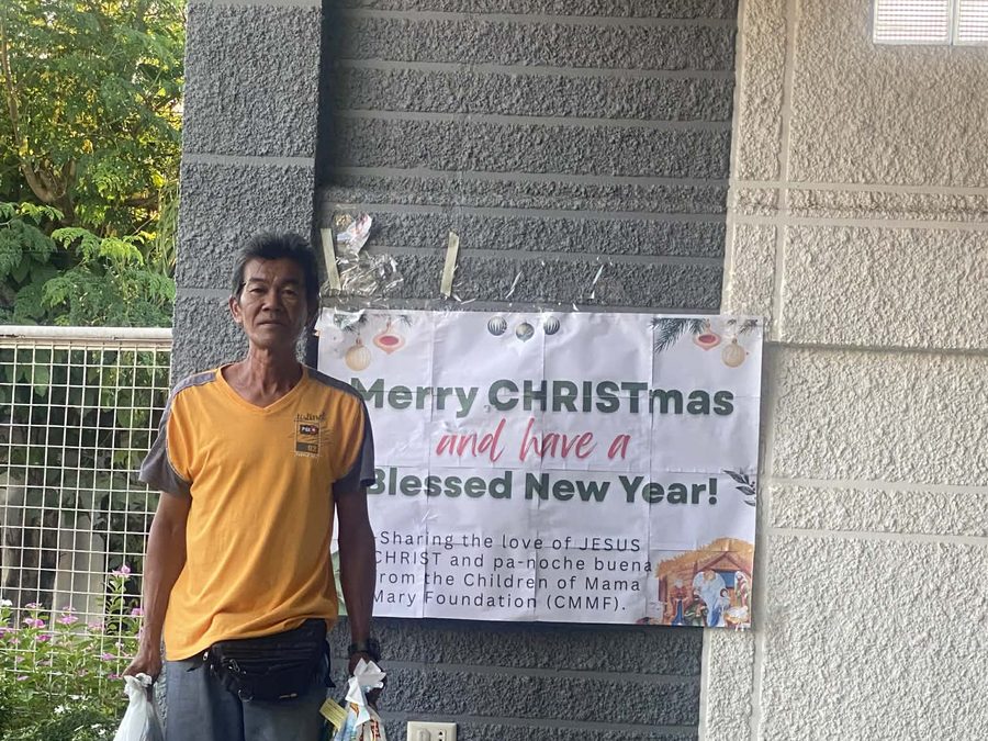 CMMF Noche Buena distribution — a family receiving Christmas aid